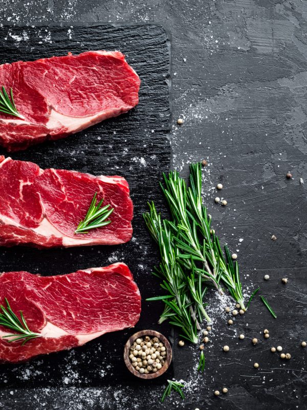 Raw,Meat,,Beef,Steak,On,Black,Background,,Top,View